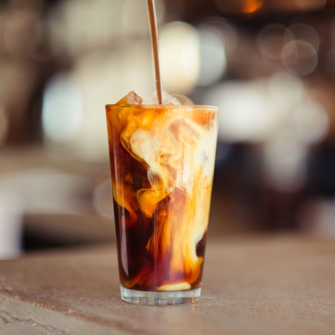 glass of iced coffee with cream and maple syrup 